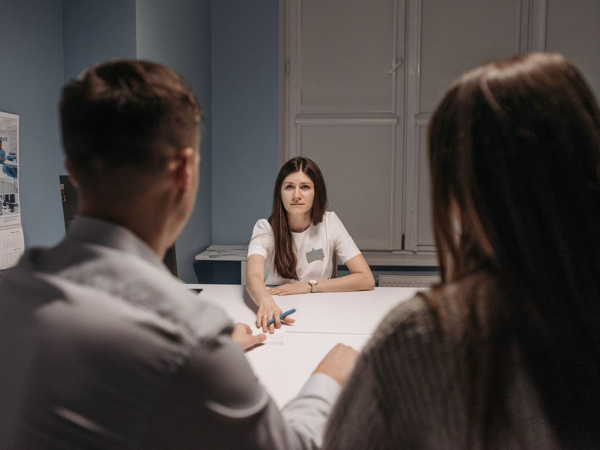 Healthcare staff in a meeting around a table in a bright office